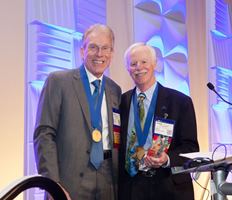 Robert Hunter, M.D., (L) at his induction as president of The Arthroscopy Association of North America with past AANA president John Richmond, M.D.