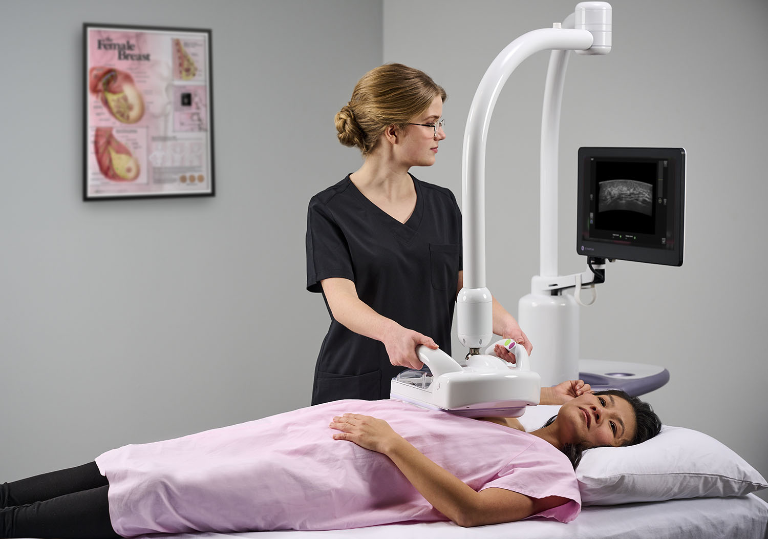 woman receiving a breast ultrasound exam